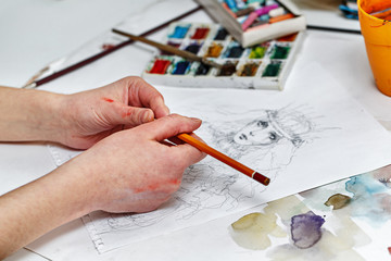 Hands of an artist working with pencil sketch