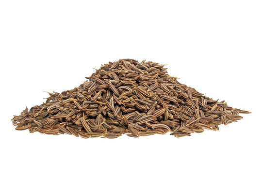 Pile of cumin seeds on a white background