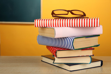 Stack of books with glasses