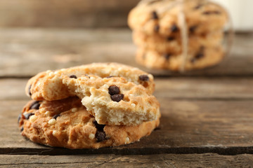 Tasty cookies and glass of milk on rustic wooden background