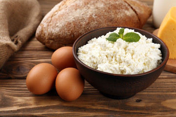 Tasty dairy products with bread on table close up