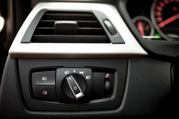 Air conditioning of automobile interior and headlight controls