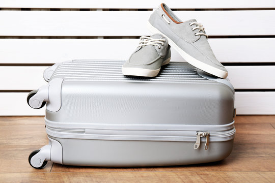 Gray suitcase with male shoes