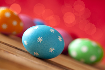 Colored Easter eggs on wooden background