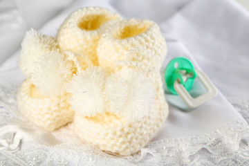 White baby boots on cloth close-up