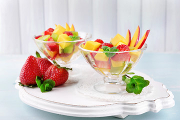 Fruit salad with mint in glassware