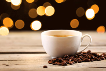 Cup of coffee on table on brown background