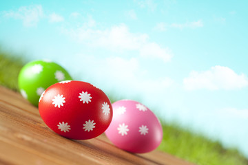 Colored Easter eggs on blue sky background