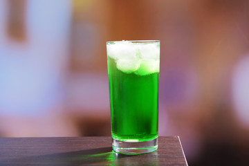 Green cocktail on table on light background