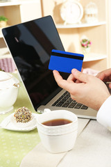 Man holding credit card and working