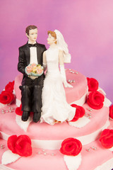 Couple on top of wedding cake