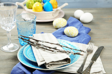 Fototapeta na wymiar Easter table setting on color wooden background
