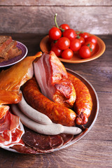 Assortment of deli meats on wooden background