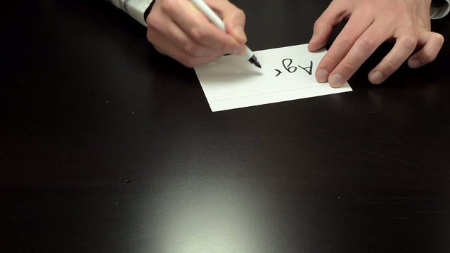 Hands writing the word agree