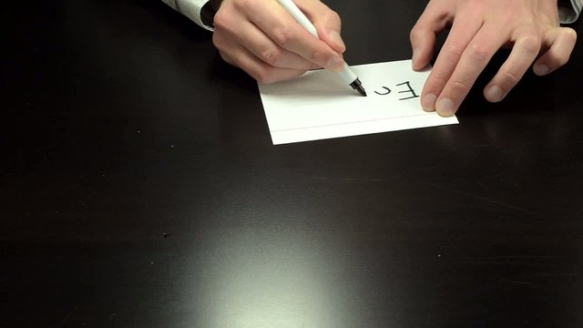 Hands writing the word enjoy