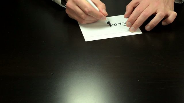 Hands writing the word exactly