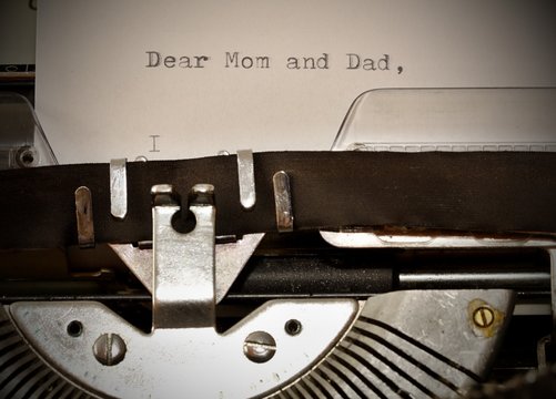 Text Dear Mom and Dad typed on old typewriter