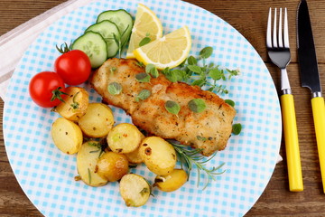 Fish fillet with rosemary potatoes, vegetables
