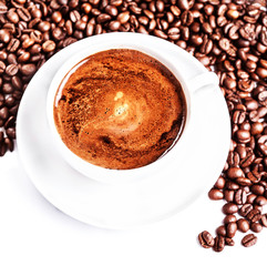 Coffee cup and saucer with roasted coffee beans isolated on a wh