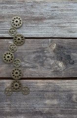 row of gears on a wooden background