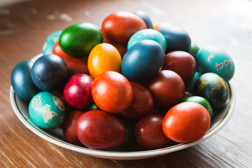 Easter eggs on plate. Colorful handmade painted holiday attribute