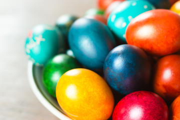 Fototapeta na wymiar Easter eggs on plate. Colorful handmade painted holiday attribute