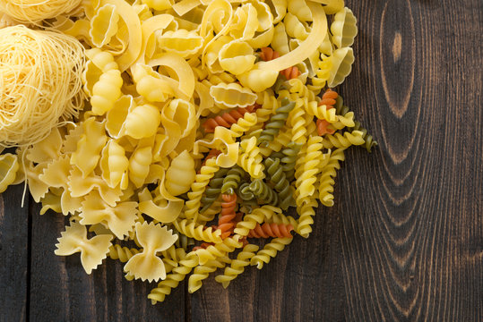 Various pasta on a paper background.