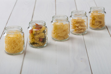 Various pasta on the wooden table