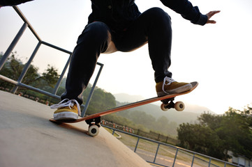 skateboarder jumping on sunrise skatepark