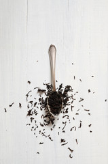 Black tea leaves on a white table