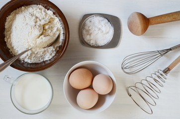 Baking ingredients: flour, milk, eggs, salt.