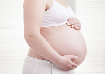 Pregant woman holding his belly
