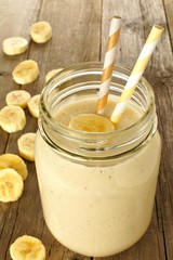 Banana oatmeal breakfast smoothie in mason jar on wood table