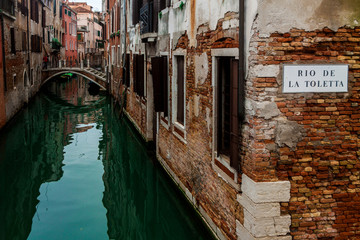 a romantic corner on a green canal in Venice