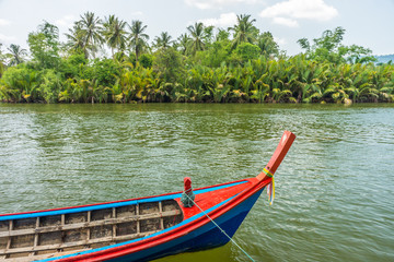 Fototapeta premium The nature view of Takua Pa river and vintage boat in countrysid