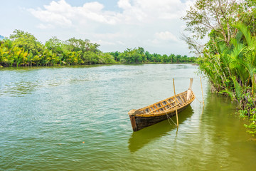 The traditional Thai wooden boat in natural Takua Pa river