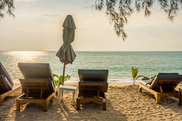 Beach umbrella and sunbath seats on Pak Weep beach in Thailand