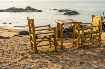 Bamboo chairs and table on Pak Weep beach in Southern Thailand