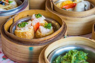 Small steamer baskets of Dim Sum in restaurant