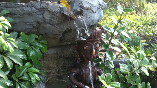 decorative small fountain in buddhist temple garden