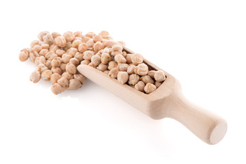 Uncooked chickpeas and wooden scoop