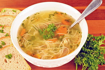 Bowl with chicken soup, vegetables and chicken meat
