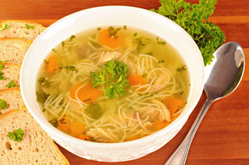 Bowl with chicken soup with vegetables and chicken meat