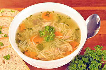 Bowl with chicken soup with vegetables and chicken meat
