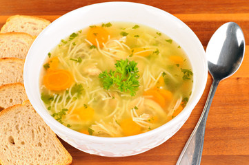 Bowl with chicken soup with vegetables and chicken meat