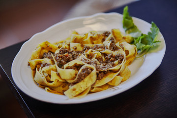A plate of pasta and meat. Tuscany. Italy