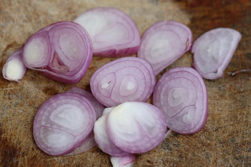 Sliced shallot on chopping block.