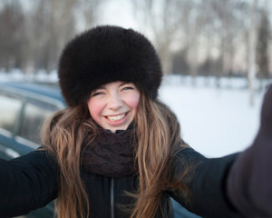 Smiling girl in the winter in the European park