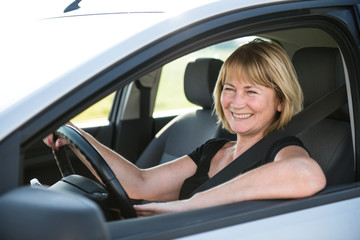 Fototapeta na wymiar Mature woman driving car