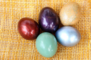 Colorful easter eggs on bamboo weave sheet background.